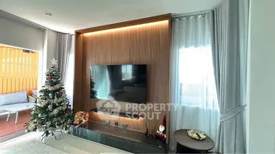 Modern living room with stylish TV wall unit and Christmas decor, featuring a cozy balcony view.