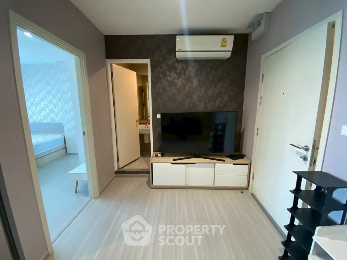 Modern living room with TV and air conditioning in stylish apartment