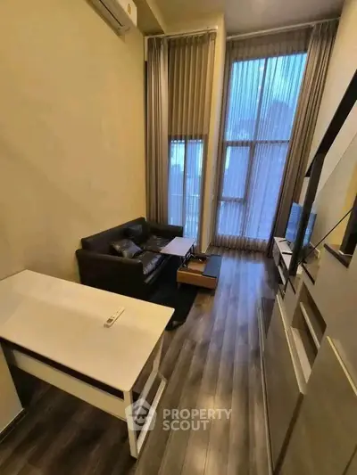 Modern living room with high ceilings and sleek furniture in a stylish apartment.