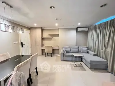 Modern living room with stylish furniture and dining area in open layout apartment.