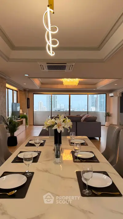 Luxurious open-plan living and dining area with city view, elegant decor, and modern lighting.