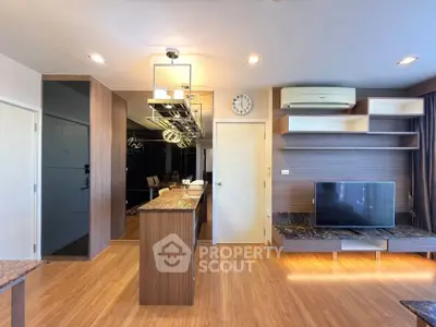 Modern living room with stylish wooden flooring and sleek TV setup