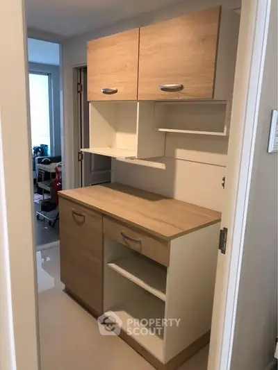 Modern storage unit in a sleek apartment interior with ample shelving and cabinets.
