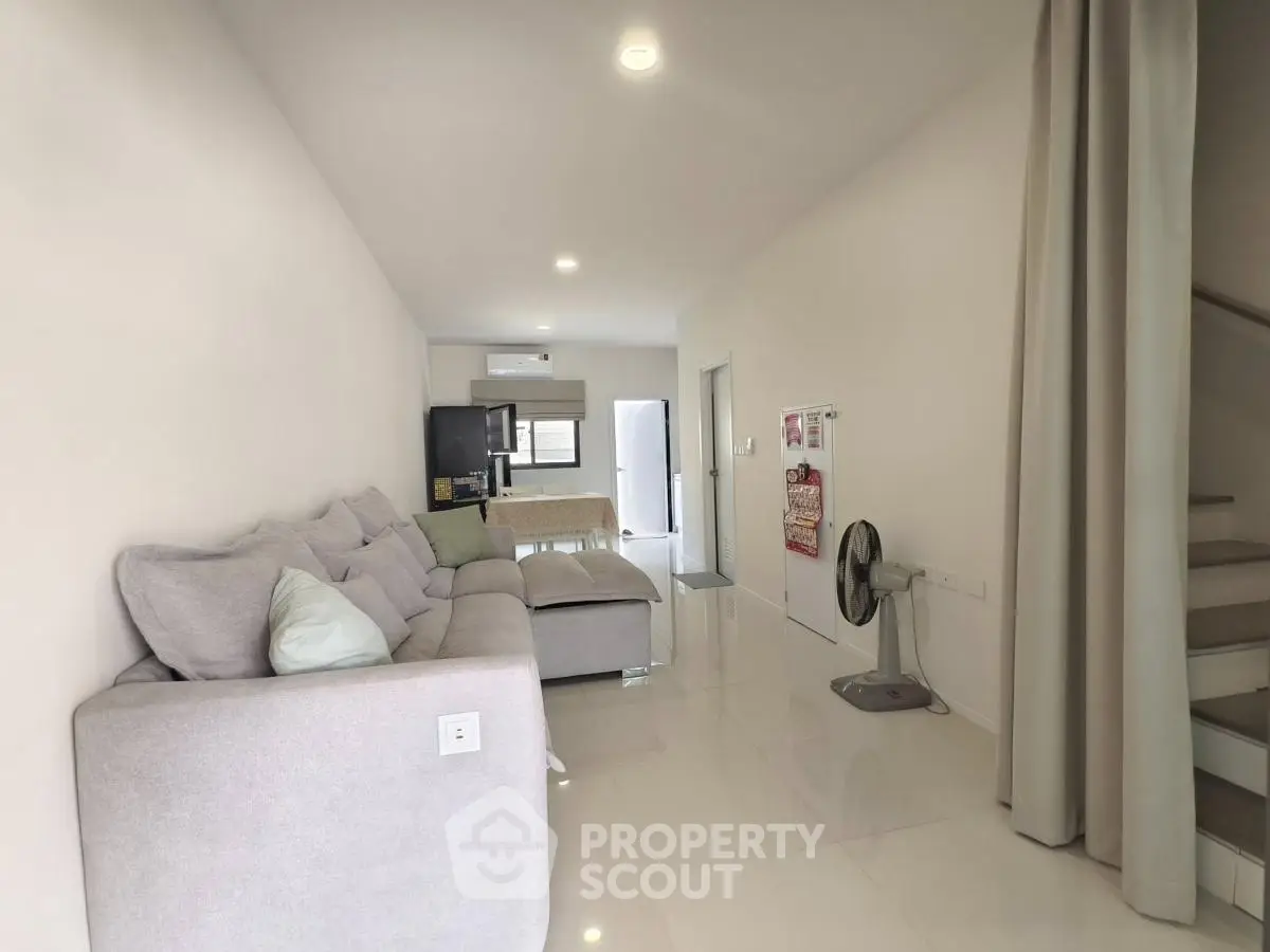 Spacious modern living room with plush sofa and sleek design, perfect for relaxation and entertaining.