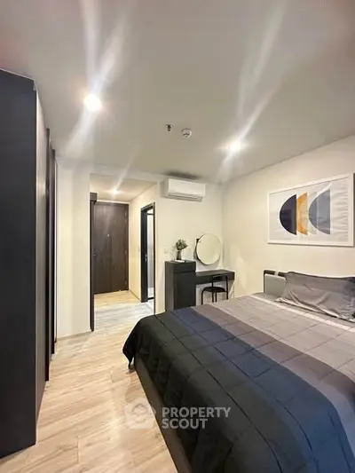 Modern bedroom with stylish decor and cozy ambiance, featuring a comfortable bed and elegant furnishings.