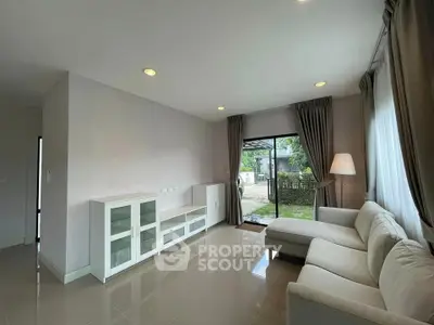 Spacious living room with modern sofa and garden view