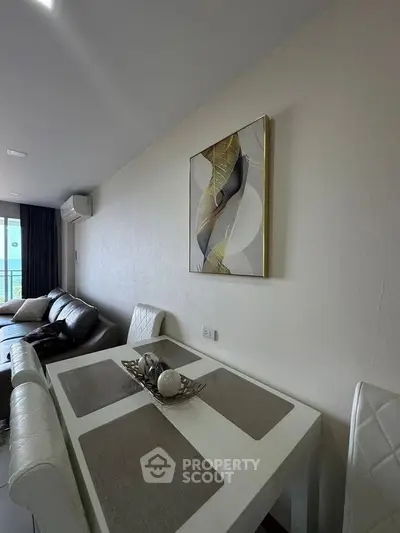 Modern living room with elegant dining area and stylish wall art