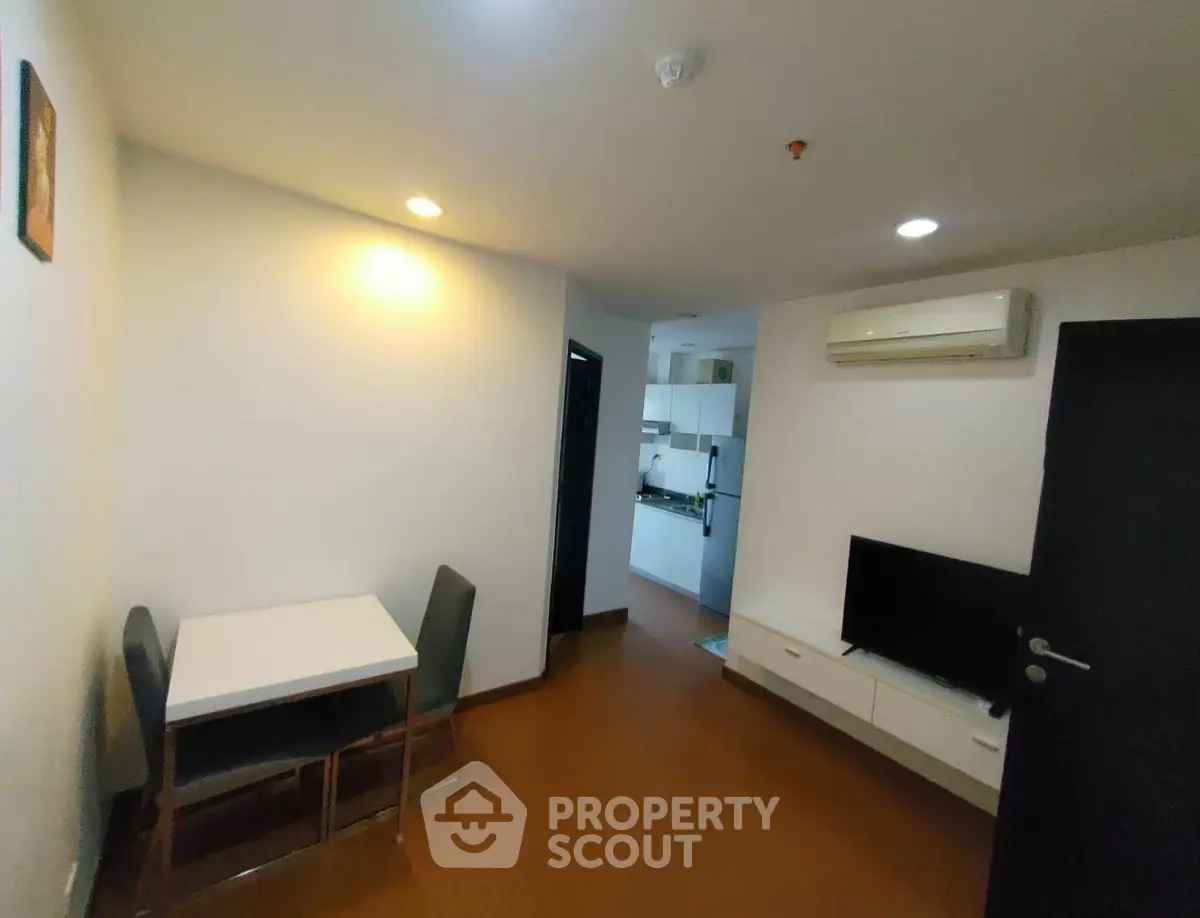 Cozy living room with dining area and modern kitchen in compact apartment