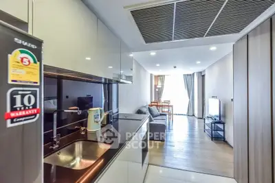 Modern open-layout kitchen and living room with sleek design and natural light.