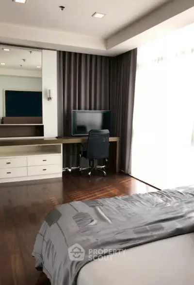 Modern bedroom with sleek desk and chair, large window with curtains, and stylish decor.
