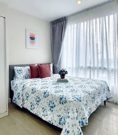 Bright and cozy bedroom with large windows and modern decor