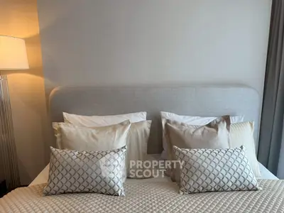 Elegant bedroom with plush pillows and soft lighting, perfect for relaxation.