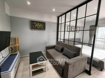 Modern living room with stylish partition and cozy sofa in contemporary apartment