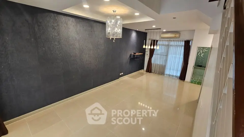 Spacious modern living room with elegant lighting and large windows for natural light.