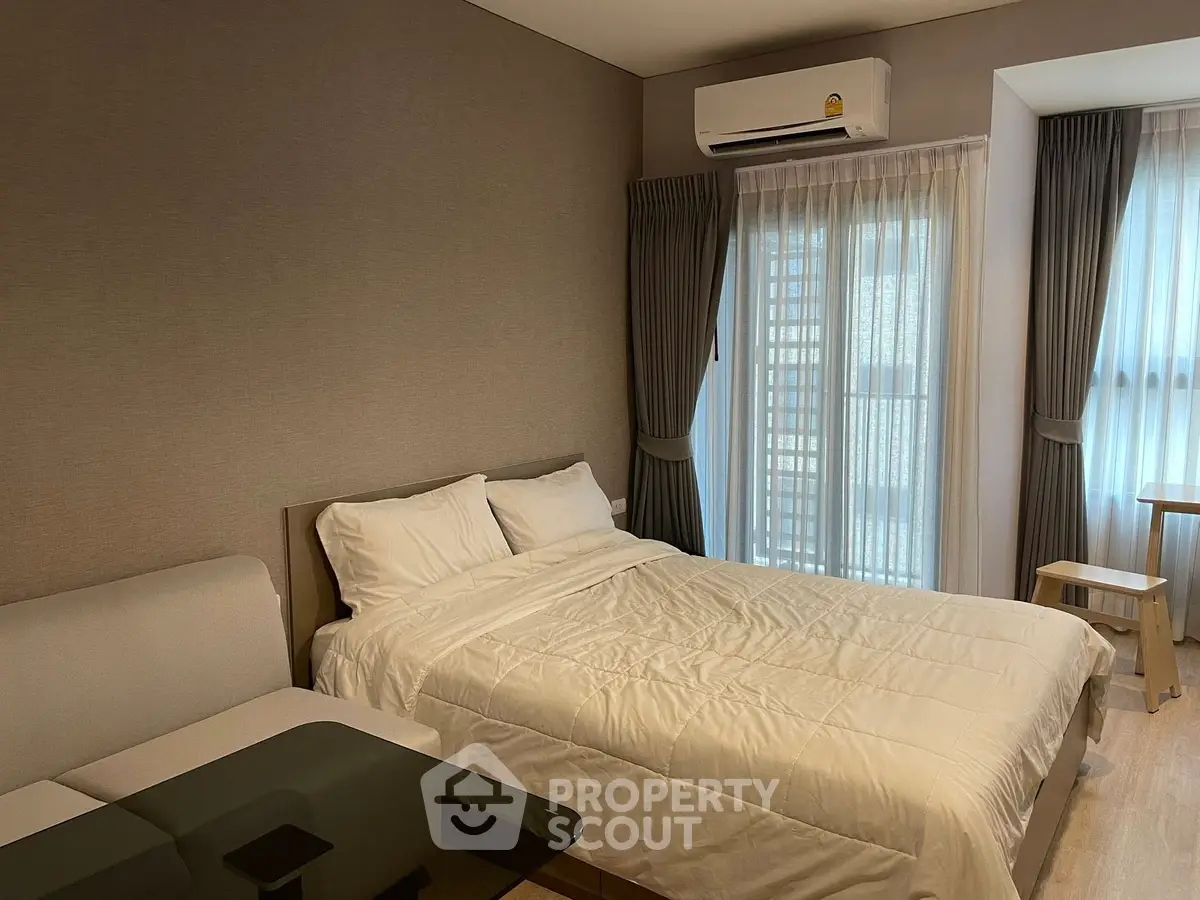 Modern bedroom with cozy bed and natural light in stylish apartment