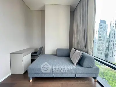 Modern living room with stylish gray sofa and city view from large window.