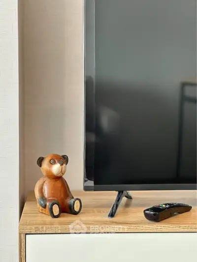Modern living room with stylish TV stand and decorative bear figurine