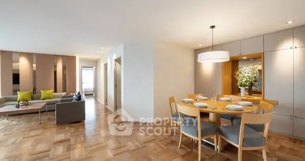 Spacious open-plan living and dining area with modern decor and parquet flooring.