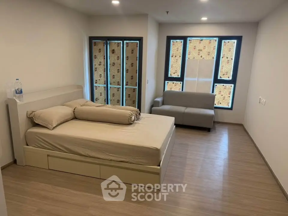 Spacious bedroom with modern decor and natural light