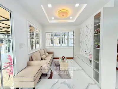 Modern living room with elegant marble accents and cozy seating area