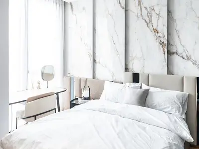 Luxurious bedroom with marble accent wall and elegant decor