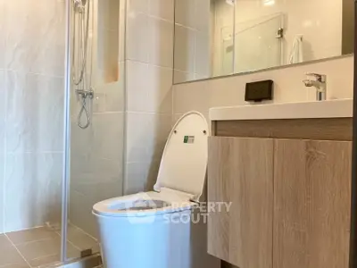 Modern bathroom with sleek fixtures and glass shower enclosure