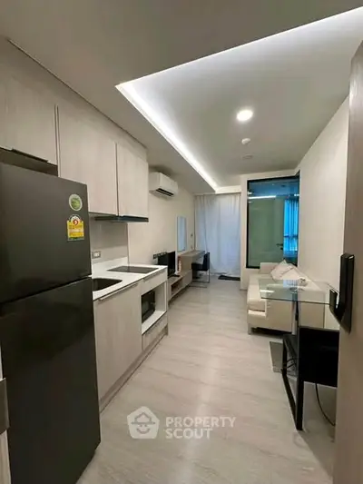 Modern apartment interior with sleek kitchen and cozy living area, perfect for urban living.