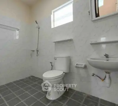 Spacious bathroom with modern fixtures and tiled flooring