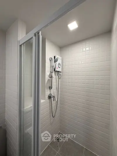 Modern bathroom with sleek shower enclosure and tiled walls