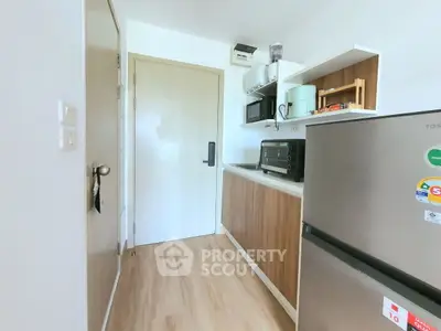 Modern kitchen with sleek appliances and wooden cabinetry
