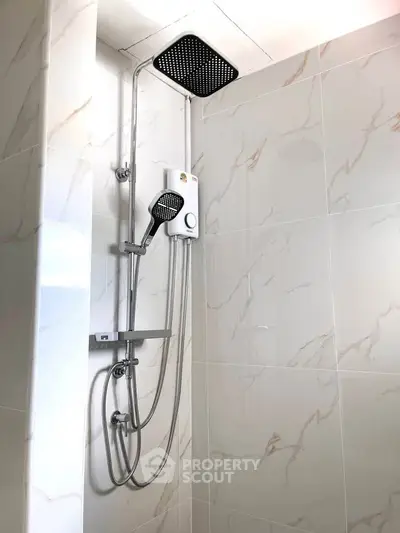 Modern bathroom with sleek shower fixtures and elegant marble tiles