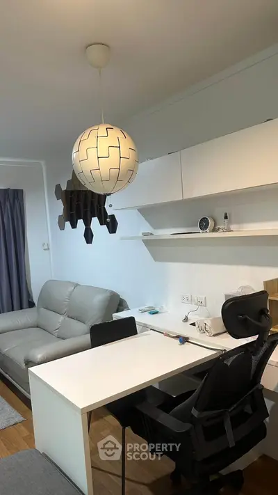 Modern living room with stylish furniture and unique lighting in a cozy apartment.
