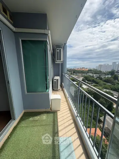 Spacious balcony with city view and artificial grass flooring.