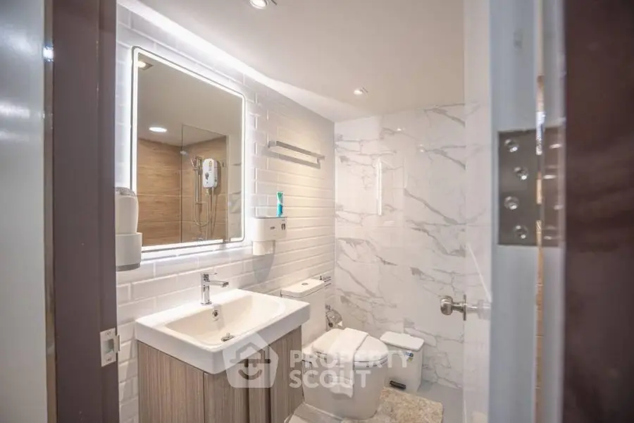 Modern bathroom with sleek fixtures and marble accents