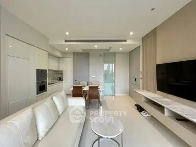 Modern open-layout living room with sleek kitchen and stylish furniture