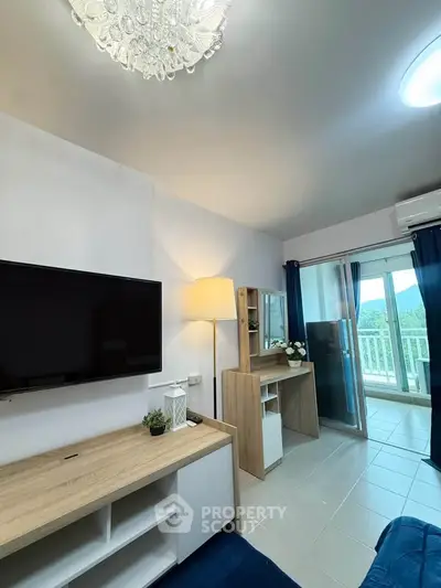 Modern living room with balcony view, featuring sleek furniture and elegant lighting.