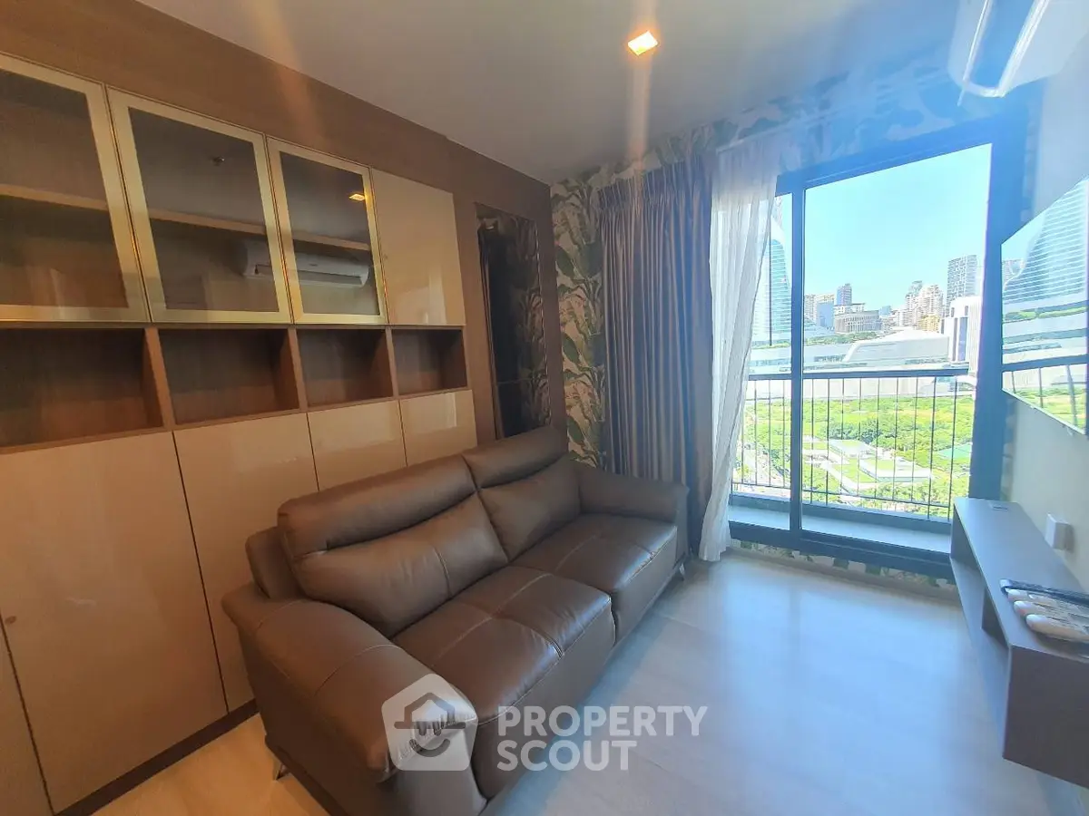 Modern living room with city view, featuring a sleek leather sofa and stylish cabinetry.