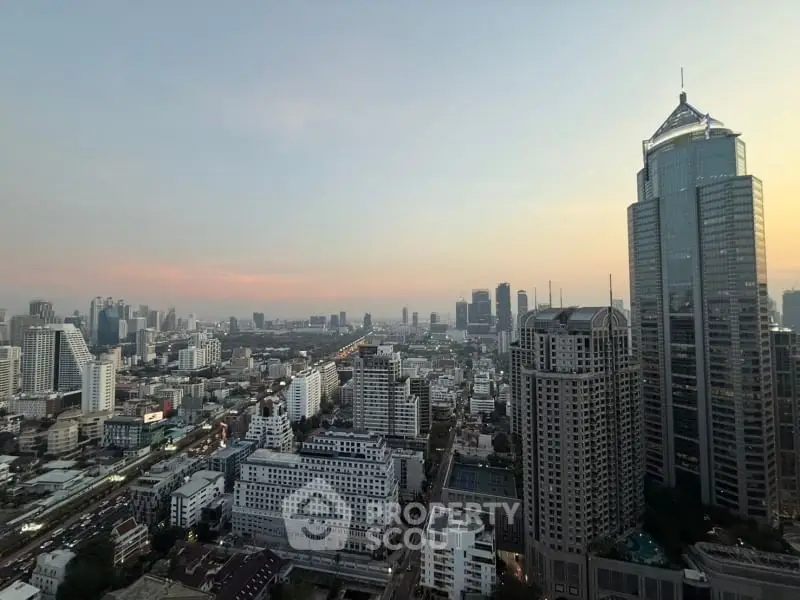 Stunning cityscape view from high-rise building at sunset, showcasing urban skyline and architectural marvels.