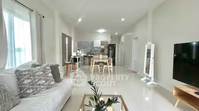 Spacious open-plan living room with modern kitchen and elegant decor