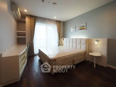 Spacious bedroom with modern design and large window for natural light
