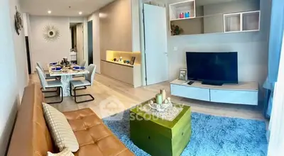 Modern living room with stylish decor, cozy seating, and a dining area, perfect for entertaining guests.