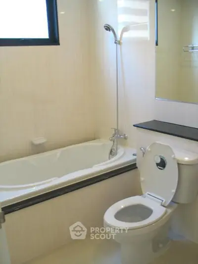 Modern bathroom with bathtub and sleek fixtures in a bright, minimalist design.