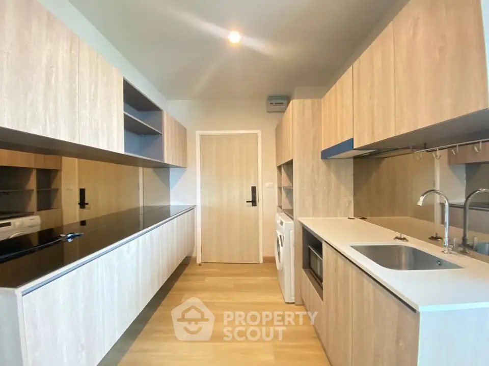 Modern kitchen with sleek cabinetry and built-in appliances in a stylish apartment.