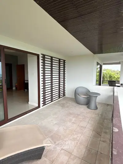 Spacious balcony with modern furniture and scenic views, perfect for relaxation and entertaining.
