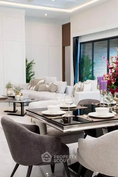 Luxurious modern living room with elegant dining setup and plush seating.