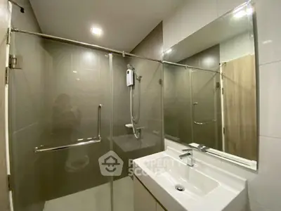 Modern bathroom with glass shower enclosure and sleek sink design
