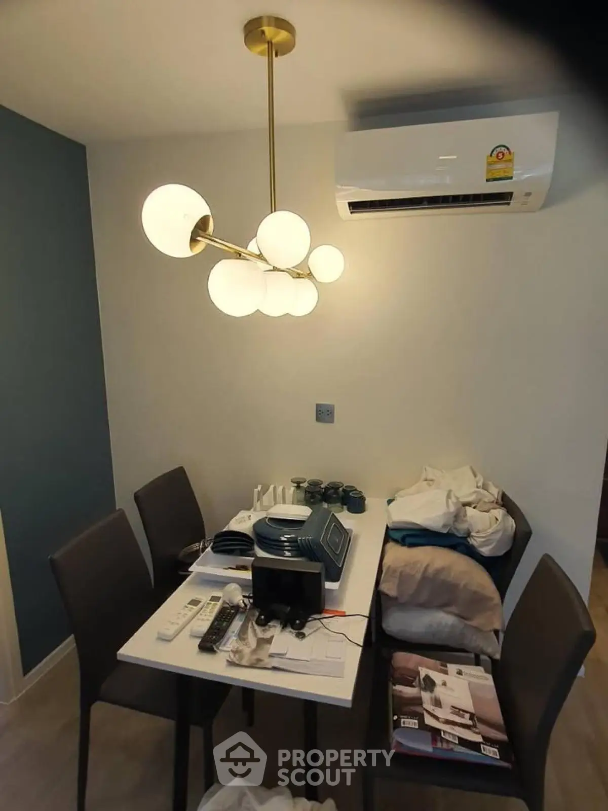 Modern dining area with stylish lighting and air conditioning unit.
