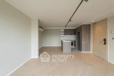 Modern open-plan living room with sleek kitchen and wooden flooring