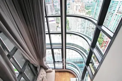 Stunning high-rise apartment with floor-to-ceiling windows offering breathtaking city views.