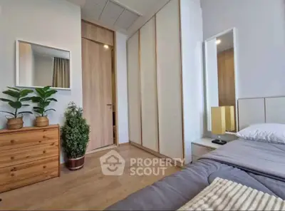 Modern bedroom with wooden flooring and minimalist decor